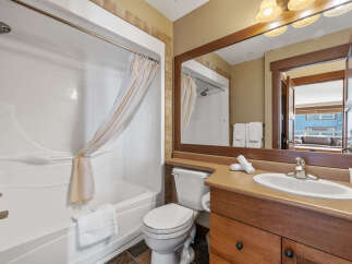 This stunning bathroom features a modern design with a sleek white bathtub and a stylish vanity.