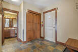 Step into this inviting entryway, featuring a warm color palette and stylish tile flooring.
