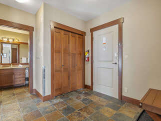 Step into this inviting entryway, featuring a warm color palette and stylish tile flooring.