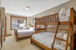 This cozy bedroom features a unique bunk bed setup, perfect for accommodating guests or family.