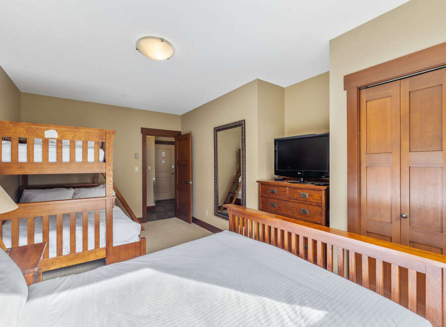 This cozy bedroom features a bunk bed, perfect for accommodating guests or family.
