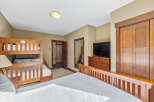 This cozy bedroom features a bunk bed, perfect for accommodating guests or family.