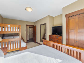 This cozy bedroom features a bunk bed, perfect for accommodating guests or family.