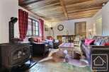 Experience rustic charm in this inviting living space, featuring a cozy fireplace and exposed wooden beams.
