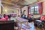 Experience rustic charm in this inviting living space, featuring a cozy fireplace and exposed wooden beams.