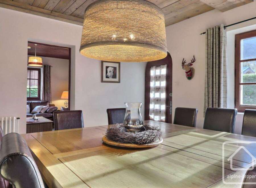 This stunning dining room features a large wooden table, perfect for hosting gatherings.
