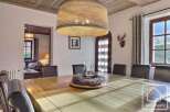 This stunning dining room features a large wooden table, perfect for hosting gatherings.