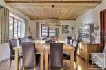 This stunning dining room showcases a rustic charm with its wooden ceiling and elegant dining table.