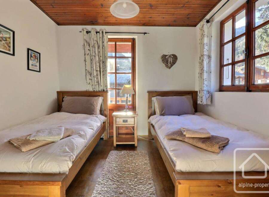 This charming bedroom features two single beds, perfect for a cozy stay.