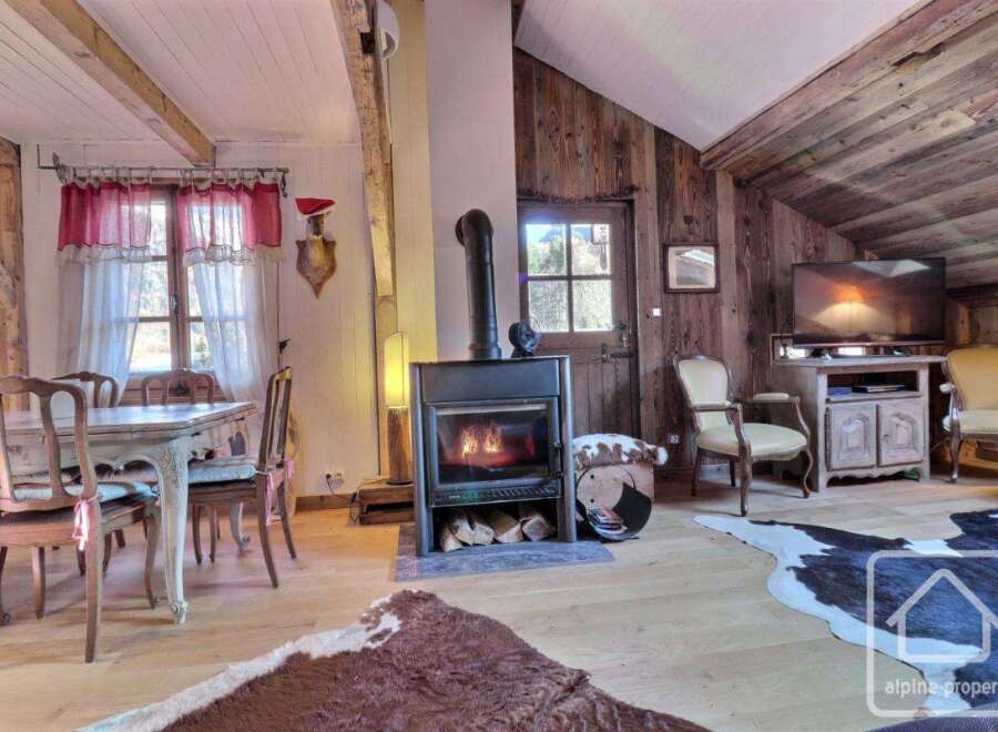 Discover the charm of this cozy property, featuring a rustic fireplace and wooden accents that create a warm and inviting atmosphere.