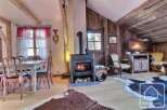 Discover the charm of this cozy property, featuring a rustic fireplace and wooden accents that create a warm and inviting atmosphere.