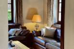 This cozy living room features comfortable leather sofas, perfect for relaxing after a long day.