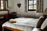 This cozy bedroom features a comfortable bed with soft linens, perfect for a relaxing stay.