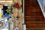 Discover the charm of this property, featuring a beautifully crafted wooden staircase and rustic interior details.