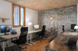 This modern office space boasts a unique blend of rustic charm and contemporary design.