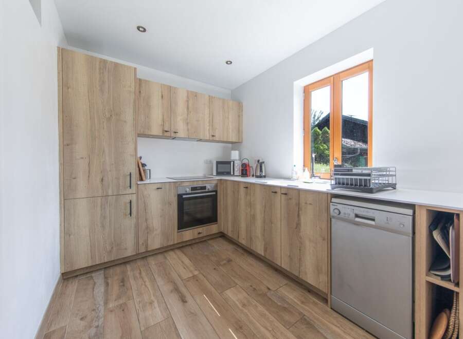 This modern kitchen boasts a sleek design with light wood cabinetry and a bright, airy feel.