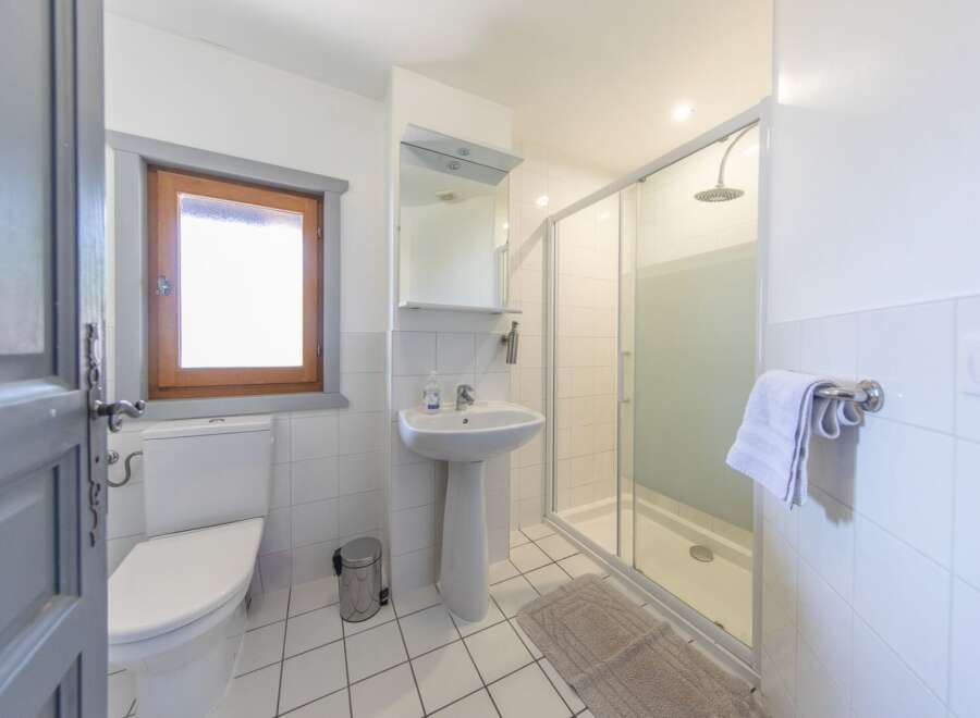 This charming bathroom features a bright and airy design, perfect for a relaxing retreat.