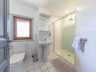 This charming bathroom features a bright and airy design, perfect for a relaxing retreat.