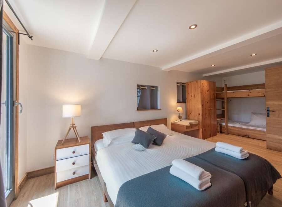 This cozy bedroom features a comfortable bed with soft linens and a stylish design.