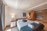 This cozy bedroom features a comfortable bed with soft linens and a stylish design.