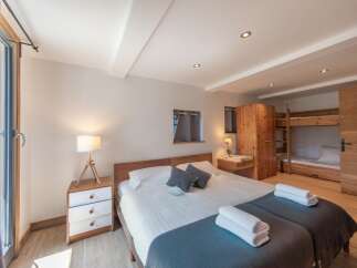 This cozy bedroom features a comfortable bed with soft linens and a stylish design.