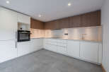 This modern kitchen boasts sleek, minimalist design with clean lines and ample storage.