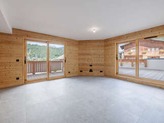This stunning property boasts a bright and airy interior, featuring beautiful wooden walls and large windows that offer breathtaking views.