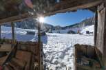 Discover a winter wonderland retreat! This charming property boasts stunning views of snow-covered mountains and a bright blue sky.
