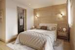 Step into a serene bedroom retreat, featuring a cozy bed with plush bedding and a stylish wooden accent wall.