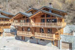 Discover the epitome of luxury living in this stunning wooden chalet nestled in a picturesque mountain setting.