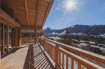 Enjoy breathtaking mountain views from this stunning wooden balcony.