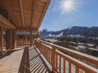 Enjoy breathtaking mountain views from this stunning wooden balcony.