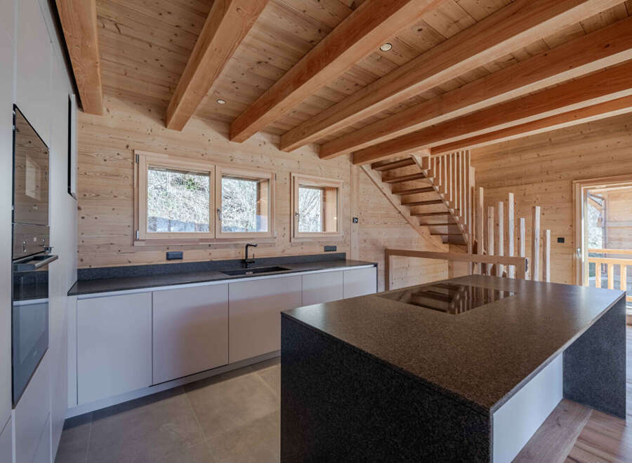 This stunning kitchen boasts a warm, inviting atmosphere with its natural wood finishes and modern design.