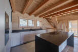 This stunning kitchen boasts a warm, inviting atmosphere with its natural wood finishes and modern design.