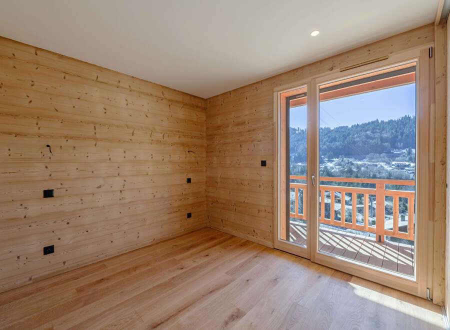 Experience the warmth of this inviting space, featuring stunning wood paneling and flooring that exudes natural charm.