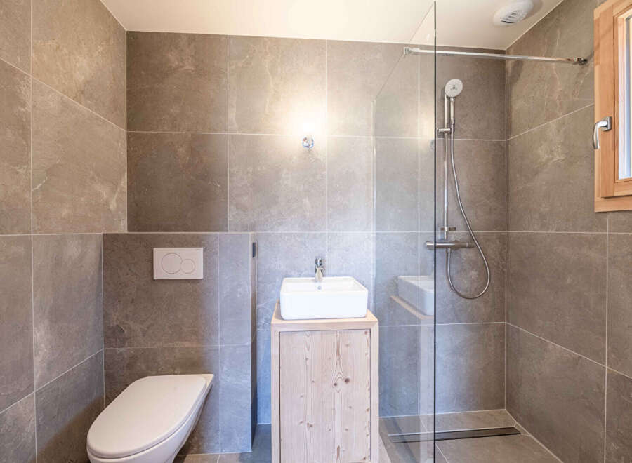 Step into a modern bathroom oasis! This beautifully designed space features sleek tile work, a contemporary vanity, and a glass-enclosed shower.