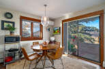 This charming dining area features a round wooden table and stylish leather chairs, perfect for intimate gatherings.