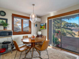 This charming dining area features a round wooden table and stylish leather chairs, perfect for intimate gatherings.