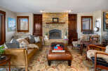Step into luxury with this stunning living room, featuring a cozy fireplace and elegant leather furniture.