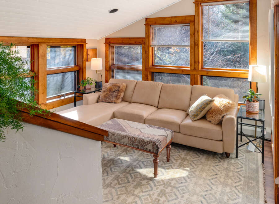 Step into this inviting living space, featuring a cozy sectional sofa and a stylish patterned rug.