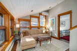 Discover the charm of this inviting living space, featuring a cozy sectional sofa and a stylish ottoman.