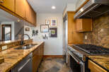 This stunning kitchen boasts a warm and inviting atmosphere, perfect for culinary enthusiasts.
