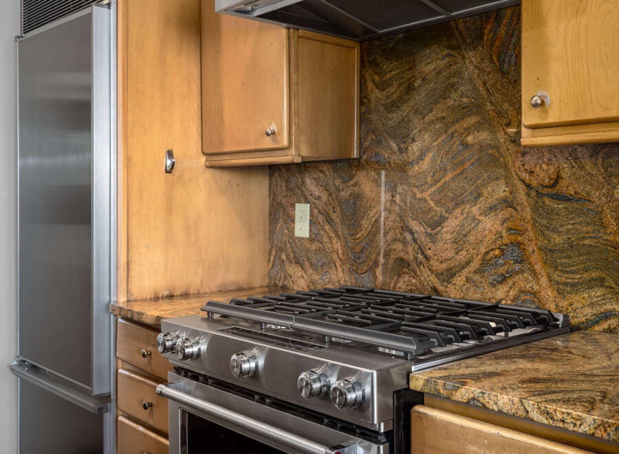 This stunning kitchen boasts a stainless steel gas range, perfect for culinary enthusiasts.