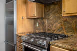 This stunning kitchen boasts a stainless steel gas range, perfect for culinary enthusiasts.
