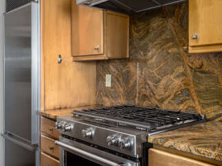This stunning kitchen boasts a stainless steel gas range, perfect for culinary enthusiasts.