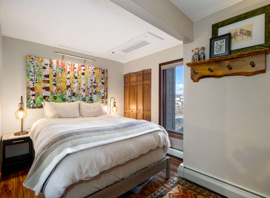 Step into this inviting bedroom, featuring a stunning piece of art above the bed, creating a focal point that elevates the space.