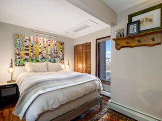 Step into this inviting bedroom, featuring a stunning piece of art above the bed, creating a focal point that elevates the space.
