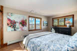 This bedroom offers a serene retreat with its tasteful decor and abundant natural light.