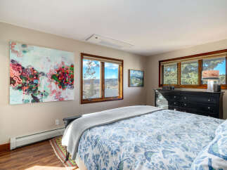 This bedroom offers a serene retreat with its tasteful decor and abundant natural light.