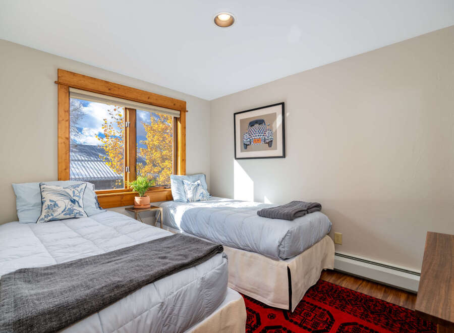 This cozy bedroom features two twin beds, perfect for guests or a shared living space.